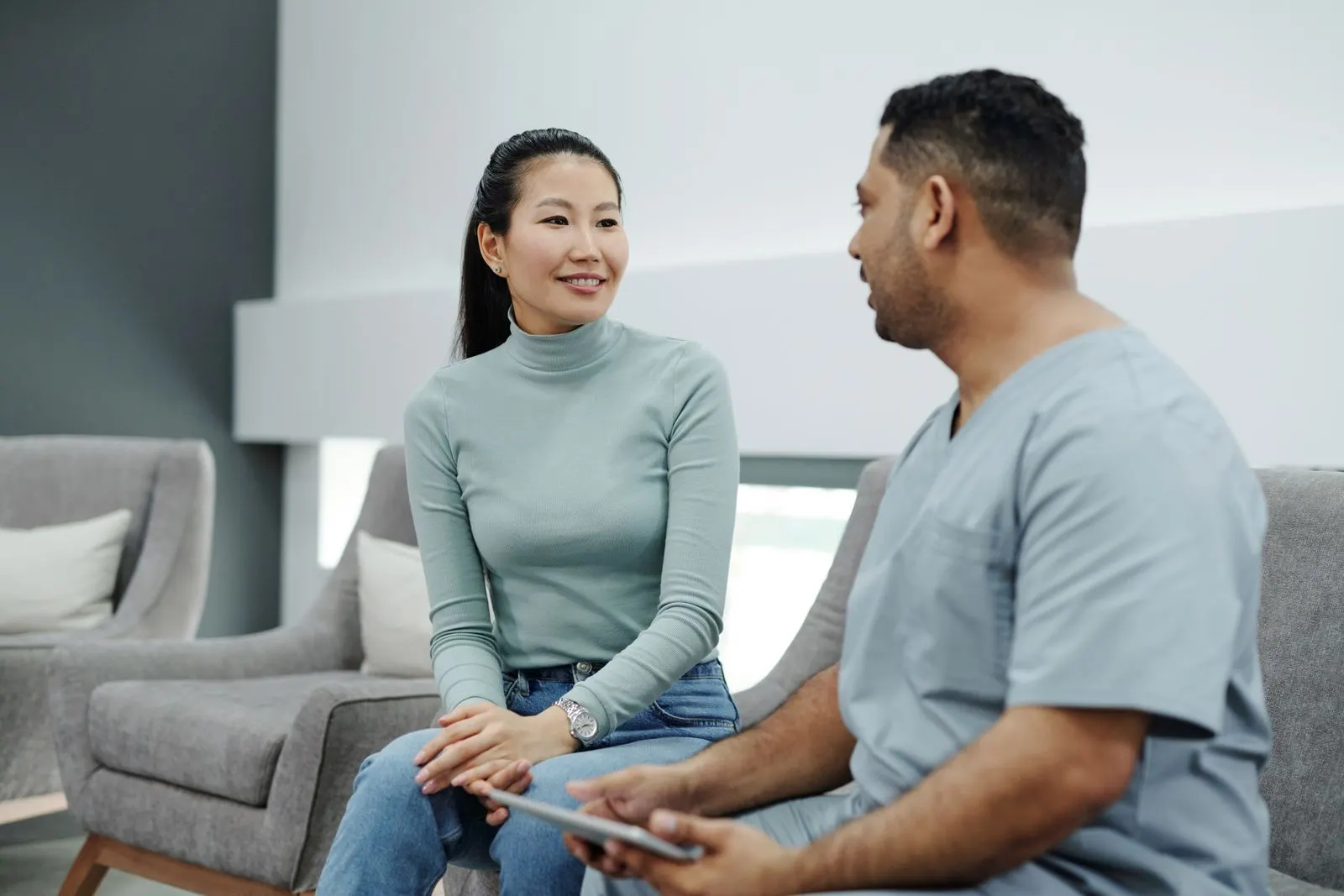 A physician and patient reviewing information together on a tablet
