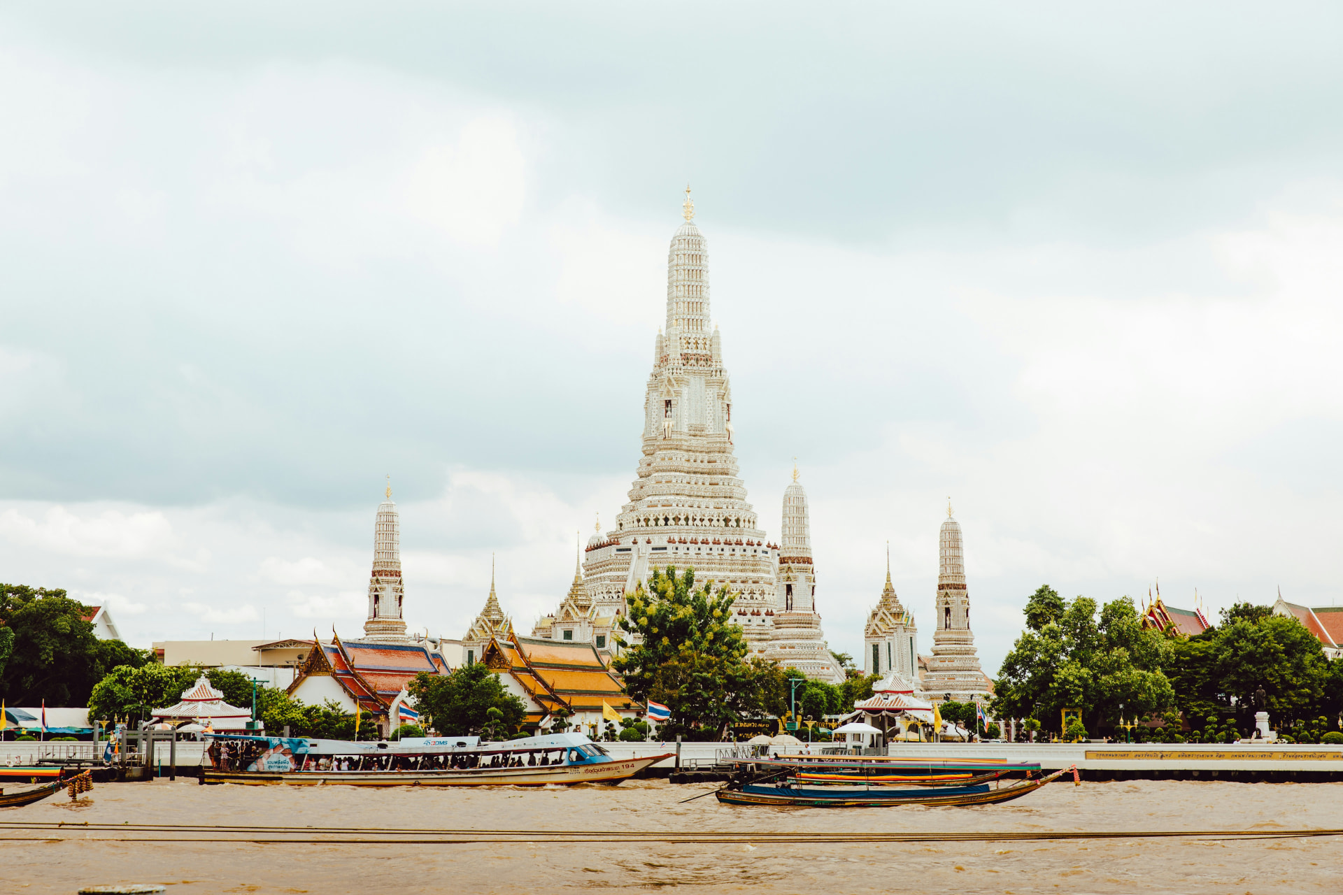 Wat Arun temple at sunset, viewed from the Chao Phraya River in Bangkok