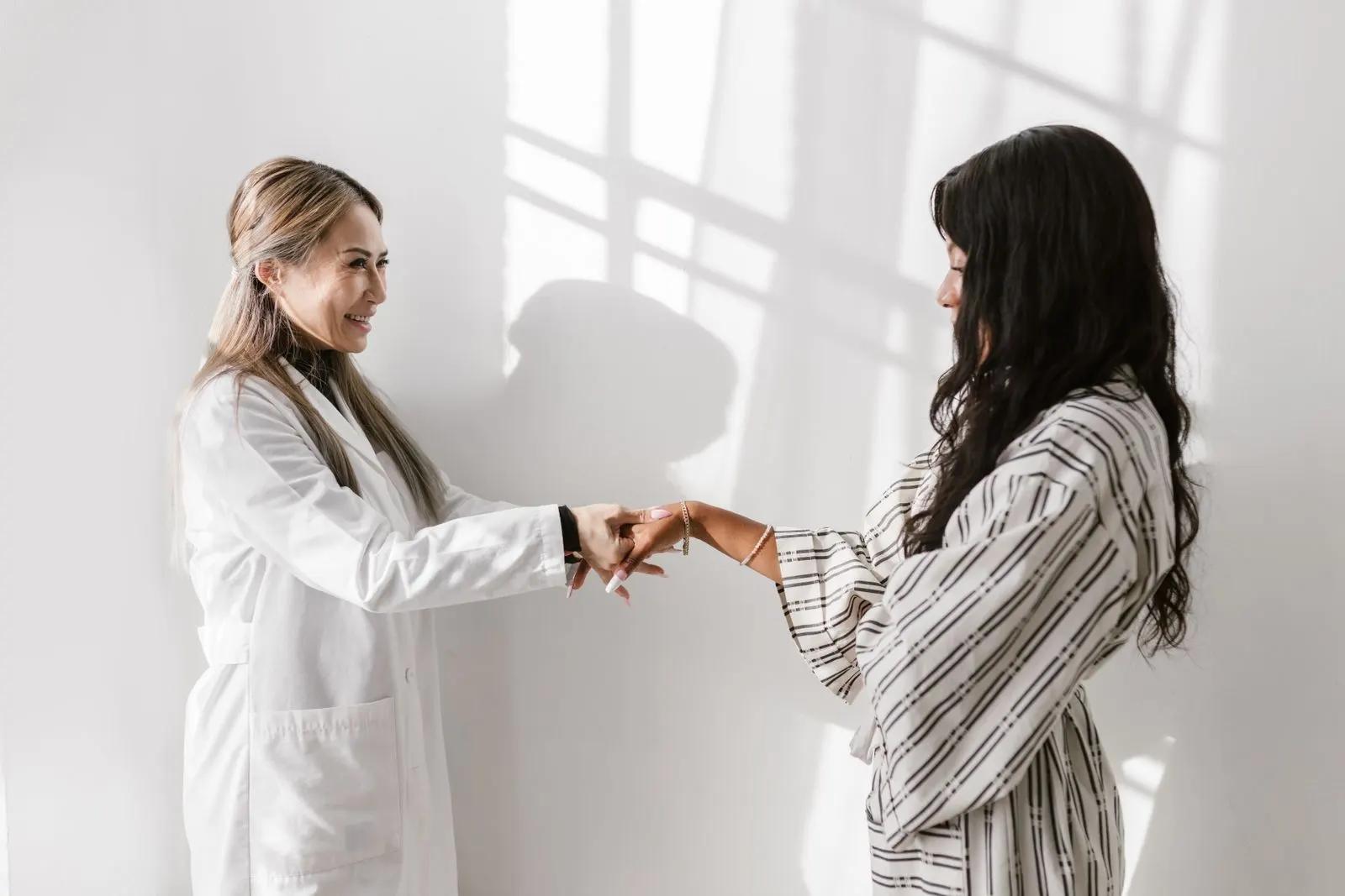 An illustrative physician greeting in a bright consultation room